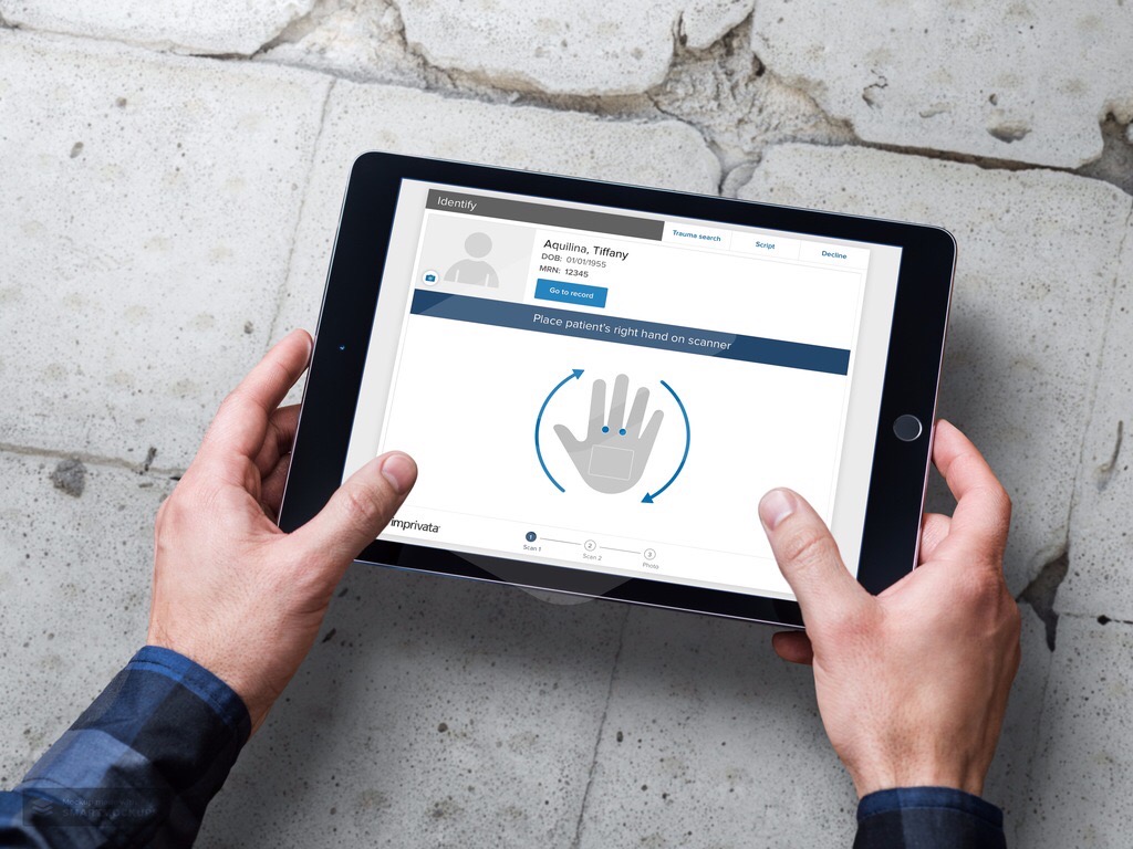 iPad showing Imprivata Patient Secure biometric palm vein scanning for patient identification
